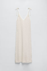 Robe mi-longue en tricot à col en V et découpes ajourées avec bretelles nouées