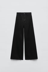 Pantalon large à lisière brute en noir, coupe slim, taille haute, coupe droite
