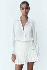 Mini-jupe plissée taille haute à boutons décoratifs