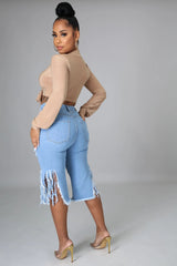 Pantalon central en jean extensible déchiré à pompons