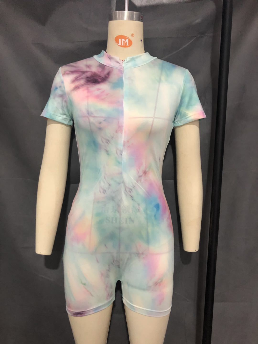 Enge, hochelastische Stramplerhose mit Batikmuster und Reißverschluss