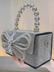 Partytasche mit glänzender Schleife und Strasssteinen
